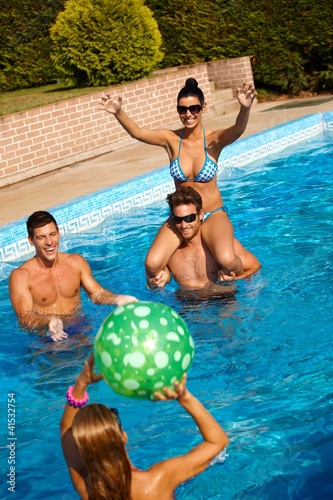 Photo: Happy people playing in swimming pool Happy people playing in swimming pool