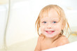 Happy baby sit in bath with shower