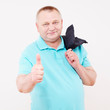 Senior man with jacket showing thump up