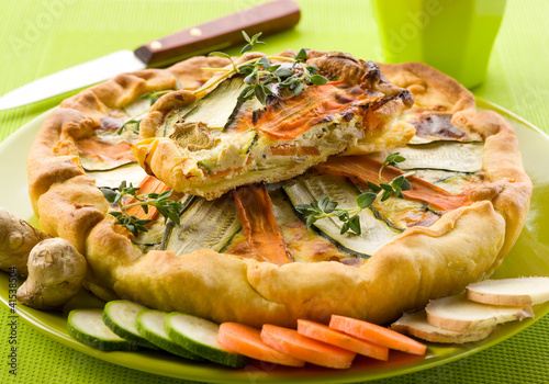 Photo: vegetables cake over dish on green background vegetables cake over dish on green background