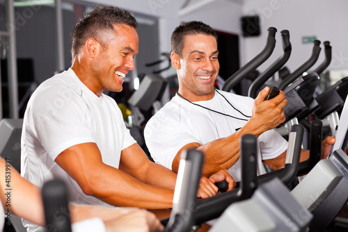 Foto: fitness man and personal trainer in gym fitness man and personal trainer in gym