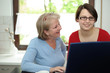 Mutter und Tochter in der Küche am Laptop