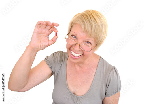 Photo: Old woman holding a pill Old woman holding a pill