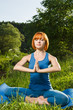 Red woman meditating outdoors