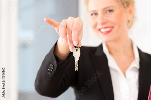 Photo: Young realtor is with keys in an apartment Young realtor is with keys in an apartment