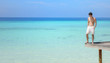 Sexy happy man standing on a pier (Maldives / Malediven)