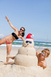 Couple having fun at beach with sandman