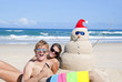 Couple having fun at beach with sandman
