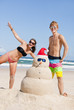 Couple having fun at beach with sandman
