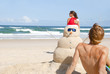 Couple having fun at beach with sandman