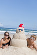 Couple having fun at beach with sandman