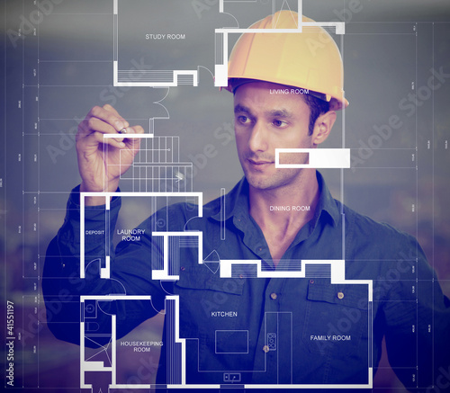 Photo: Construction worker sketching blueprints Construction worker sketching blueprints