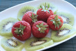 Kiwi and strawberries on a white dish Kiwi and strawberries on a white dish
