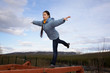 girl doing gymnastic element of the balance on a log
