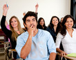 Students in a classroom rising hands