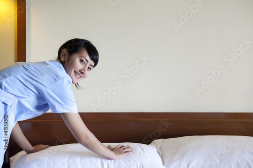 Photo: Asian maid working in hotel room Asian maid working in hotel room