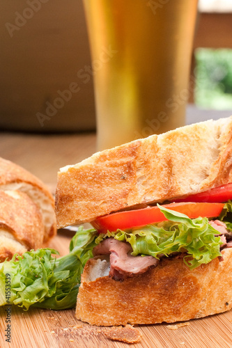 Photo: Fresh home-made roast beef sandwich with cold beer . Fresh home-made roast beef sandwich with cold beer .