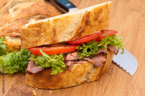 Photo: Fresh roast beef and crusty bread sandwich. Fresh roast beef and crusty bread sandwich.