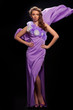 beautiful woman in the purple dress on a gray background