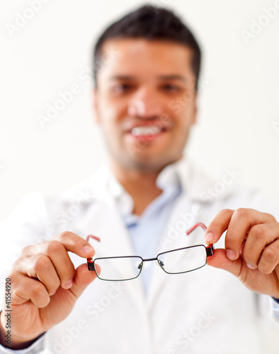Photo: Man holding glasses Man holding glasses