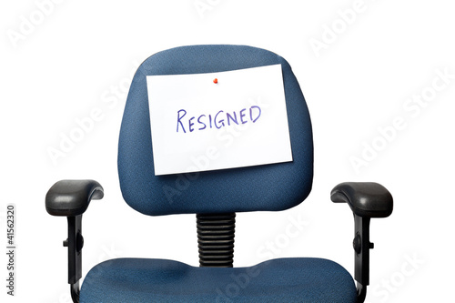 Photo: Office chair with a RESIGNED sign isolated on white Office chair with a RESIGNED sign isolated on white