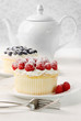 Cupcakes with raspberries and cream on table Cupcakes with raspberries and cream on table