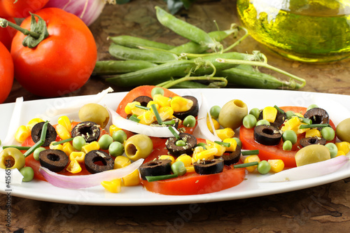 Photo: Salad of tomato, olives, corn and peas Salad of tomato, olives, corn and peas