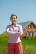 Happy mature woman against her home Happy mature woman against her home