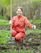 Mature woman with spade and sprouts Mature woman with spade and sprouts