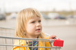 Adorable baby sit in supermarket cart
