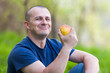 Man eating an apple outdoor Man eating an apple outdoor