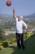 A old man with walking stick playing a basketball