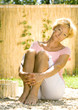 Senior woman sitting on ground outdoors
