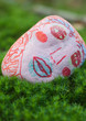 Stone decorated with face, lying on ground