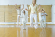 Group of adults in wellness center jumping into air