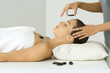 Woman receiving lastone therapy, eyes closed