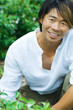 Man in garden, smiling at camera, portrait