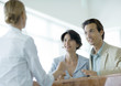 Couple at counter speaking to receptionist
