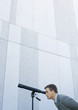 Businessman looking through telescope