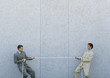Two businessmen playing tug-of-war