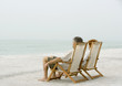 Couple sitting in beach chairs, looking at view