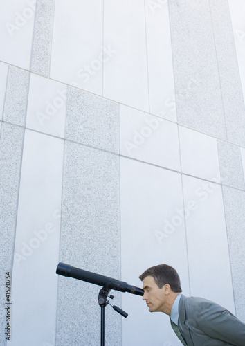 Photo: Businessman looking through telescope Businessman looking through telescope
