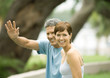 Mature couple, man waving