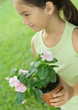 Girl holding potted plant