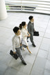 Three business executives walking side by side, high angle view