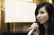 Young woman singing karaoke