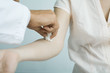 Photo: Doctor cleaning woman's arm with cotton ball Doctor cleaning woman's arm with cotton ball