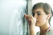 Teen girl drawing on chalkboard