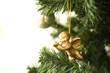 Angel Christmas ornament hanging from Christmas tree, cropped view