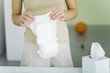 Woman holding baby diaper, cropped view